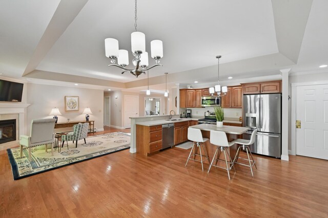 40 Camden Ct Unit 40, Bangor, ME 04401 - kitchen with appliances with stainless steel finishes, a chandelier, a tray ceiling, recessed lighting, and crown molding