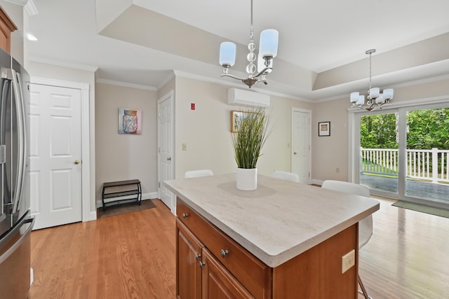 40 Camden Ct Unit 40, Bangor, ME 04401 - kitchen with a chandelier, freestanding refrigerator, a tray ceiling, light wood-type flooring, and brown cabinetry