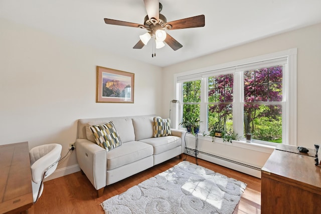 40 Camden Ct Unit 40, Bangor, ME 04401 - living room with a baseboard heating unit, ceiling fan, wood finished floors, and baseboards