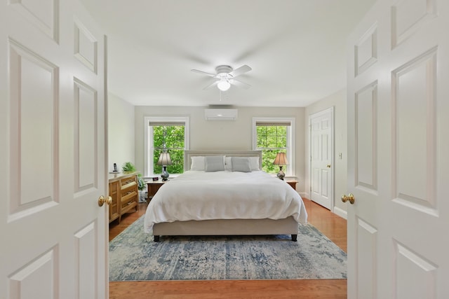 40 Camden Ct Unit 40, Bangor, ME 04401 - bedroom with a wall mounted AC, wood finished floors, and ceiling fan