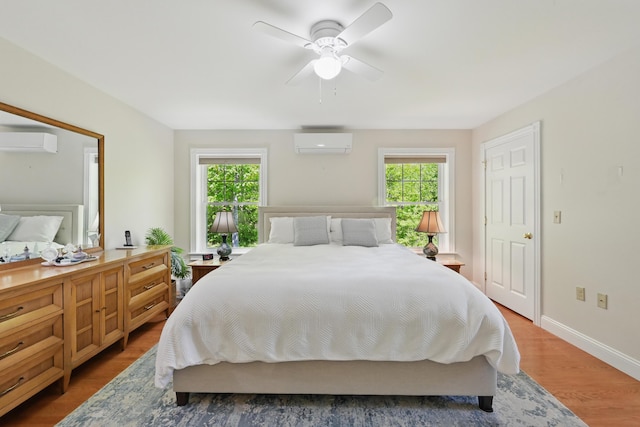 40 Camden Ct Unit 40, Bangor, ME 04401 - bedroom featuring a wall mounted air conditioner, multiple windows, and light wood-style floors