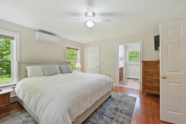 40 Camden Ct Unit 40, Bangor, ME 04401 - bedroom with an AC wall unit, a baseboard heating unit, multiple windows, and light wood finished floors