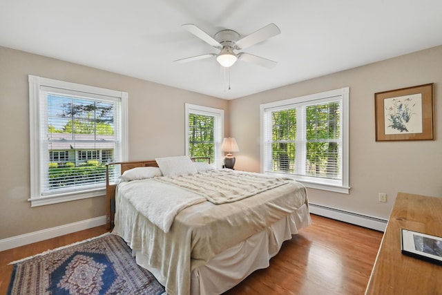 40 Camden Ct Unit 40, Bangor, ME 04401 - bedroom featuring baseboard heating, wood finished floors, baseboards, and ceiling fan