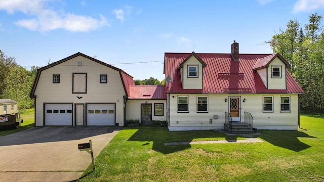 87 Southard Ave, Kenduskeag, ME 04450 - dutch colonial featuring driveway, a front yard, metal roof, a chimney, and an attached garage