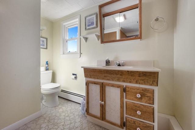 87 Southard Ave, Kenduskeag, ME 04450 - half bath with a baseboard heating unit, baseboards, toilet, and vanity
