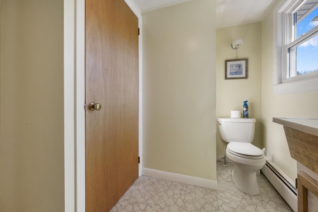 87 Southard Ave, Kenduskeag, ME 04450 - bathroom with baseboard heating, toilet, crown molding, and baseboards