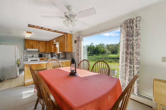 87 Southard Ave, Kenduskeag, ME 04450 - dining area featuring ceiling fan and a baseboard heating unit