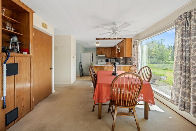 87 Southard Ave, Kenduskeag, ME 04450 - dining area with light colored carpet, a ceiling fan, and a baseboard radiator