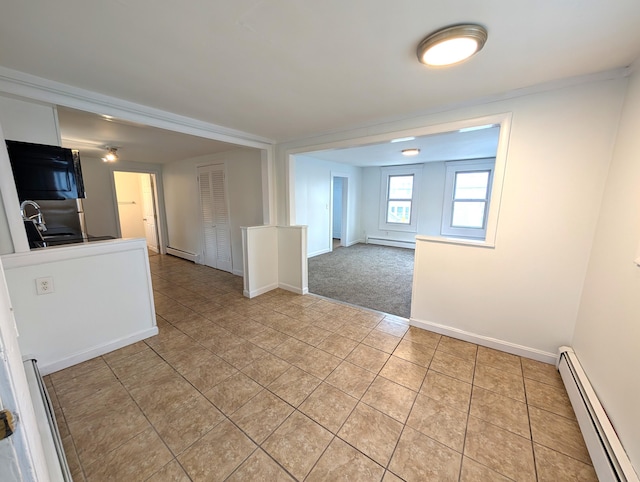 195 Elm St, Biddeford, ME 04005 - spare room featuring a baseboard radiator, light tile patterned floors, and baseboards