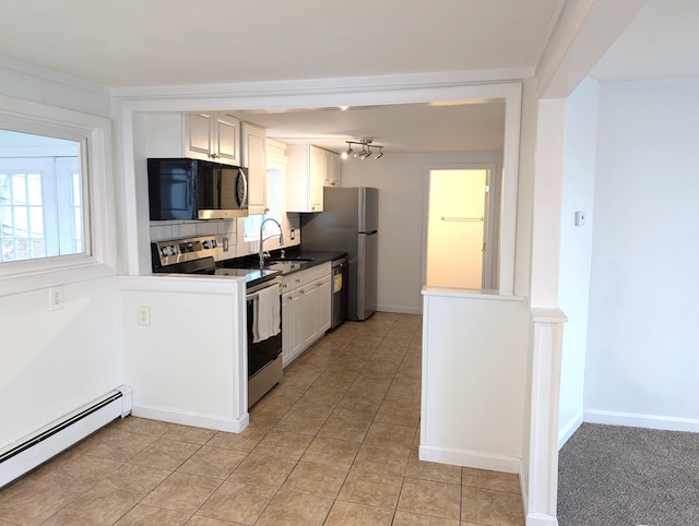 195 Elm St, Biddeford, ME 04005 - kitchen featuring stainless steel appliances, a baseboard heating unit, a sink, white cabinets, and baseboards