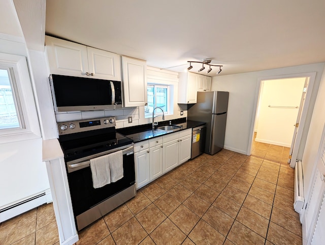 195 Elm St, Biddeford, ME 04005 - kitchen with appliances with stainless steel finishes, a sink, a baseboard heating unit, and white cabinetry