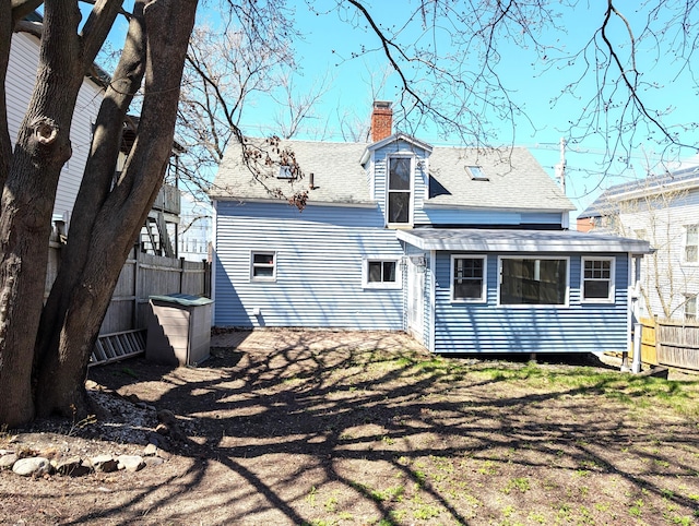 195 Elm St, Biddeford, ME 04005 - rear view of property featuring a chimney and roof with shingles