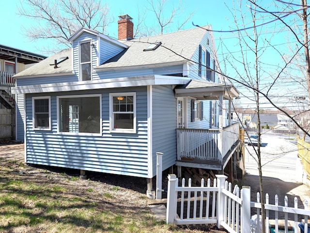 195 Elm St, Biddeford, ME 04005 - view of property exterior with a shingled roof and a chimney