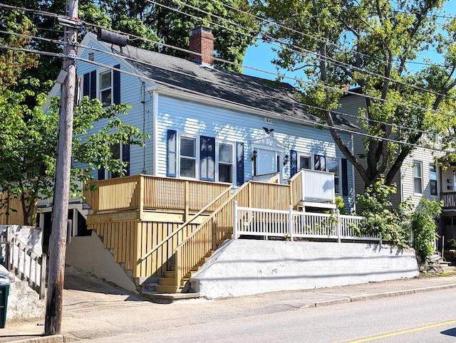 195 Elm St, Biddeford, ME 04005 - view of front facade featuring a chimney, stairs, and roof with shingles