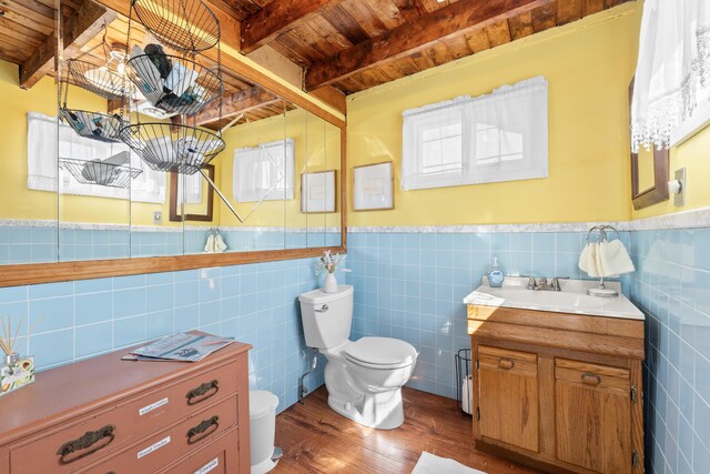 75 Ox Cart Ln Unit 2, Wells, ME 04090 - bathroom with wooden ceiling with exposed beams, toilet, wood finished floors, vanity, and tile walls