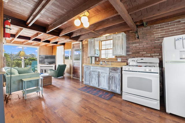 75 Ox Cart Ln Unit 2, Wells, ME 04090 - kitchen with white appliances, wooden ceiling with exposed beams, a sink, dark wood finished floors, and light countertops