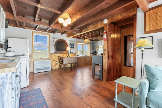 75 Ox Cart Ln Unit 2, Wells, ME 04090 - kitchen featuring white gas range oven, wood finished floors, wooden walls, wooden ceiling with exposed beams, and light countertops