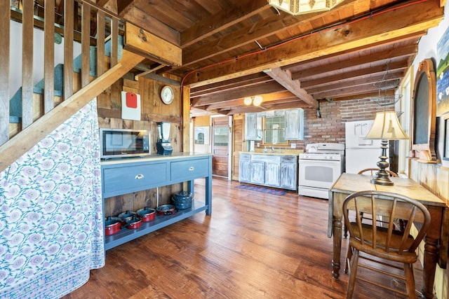 75 Ox Cart Ln Unit 2, Wells, ME 04090 - kitchen with white appliances, wood finished floors, wooden ceiling with exposed beams, wood walls, and a sink