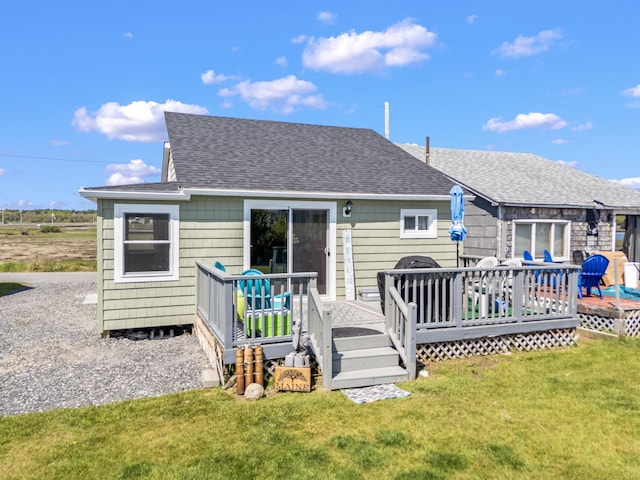 75 Ox Cart Ln Unit 2, Wells, ME 04090 - rear view of house with a shingled roof, a lawn, and a deck
