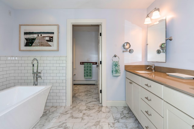 10 Pemasong Ln, Yarmouth, ME 04096 - bathroom with marble look tile flooring, baseboard heating, a freestanding bath, double vanity, and tile walls