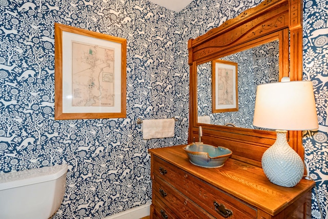 10 Pemasong Ln, Yarmouth, ME 04096 - half bathroom with wallpapered walls, toilet, and vanity