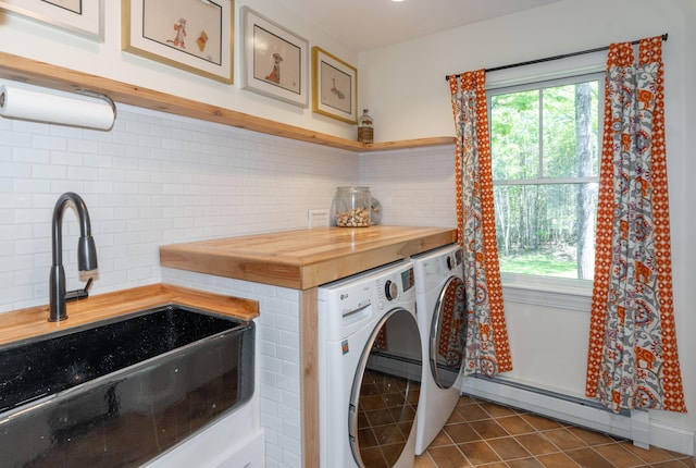 10 Pemasong Ln, Yarmouth, ME 04096 - laundry room with a baseboard radiator, washing machine and dryer, and dark tile patterned flooring