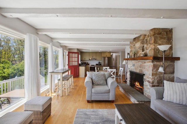 142 Fortunes Rocks Rd, Biddeford, ME 04005 - living room with a fireplace, light wood-type flooring, and beam ceiling
