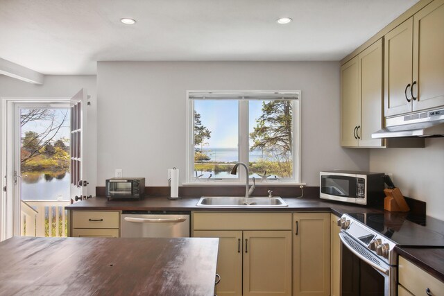 142 Fortunes Rocks Rd, Biddeford, ME 04005 - kitchen featuring appliances with stainless steel finishes, a sink, under cabinet range hood, recessed lighting, and butcher block counters