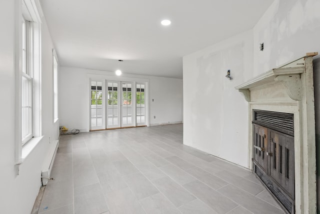 21 Surf Ln, Kennebunk, ME 04043 - unfurnished living room with a fireplace, baseboard heating, and recessed lighting