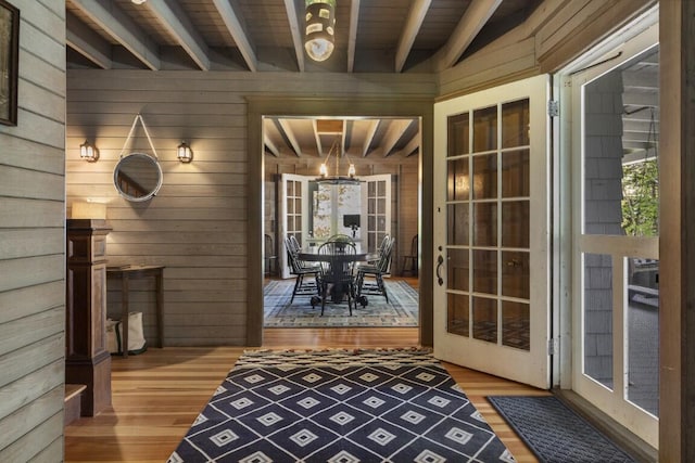 1 Mouse Is, Southport, ME 04576 - entryway featuring wooden walls, wood finished floors, a chandelier, plenty of natural light, and wood ceiling with exposed beams