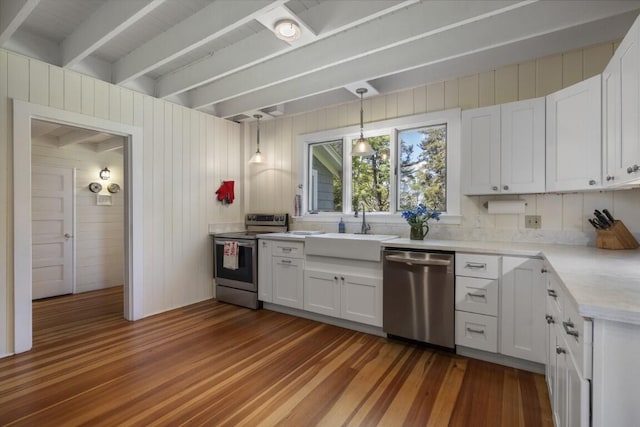 1 Mouse Is, Southport, ME 04576 - kitchen featuring appliances with stainless steel finishes, dark wood-style floors, a sink, beam ceiling, and light countertops