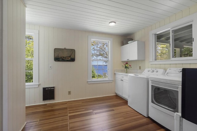 1 Mouse Is, Southport, ME 04576 - laundry area featuring cabinet space, independent washer and dryer, heating unit, dark wood finished floors, and plenty of natural light
