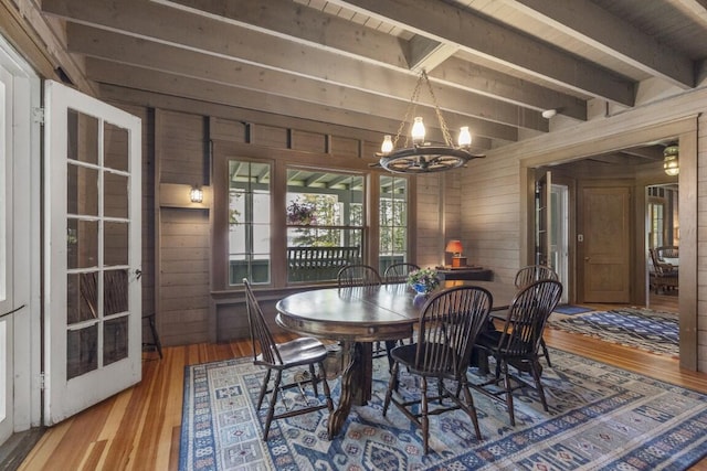 1 Mouse Is, Southport, ME 04576 - dining space featuring a chandelier, wood walls, wood finished floors, and beam ceiling