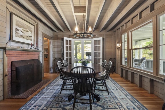 1 Mouse Is, Southport, ME 04576 - dining area with wood finished floors, wood walls, a chandelier, french doors, and wooden ceiling with exposed beams