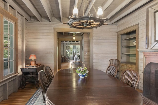 1 Mouse Is, Southport, ME 04576 - dining space featuring wood walls, a chandelier, wood finished floors, and beam ceiling
