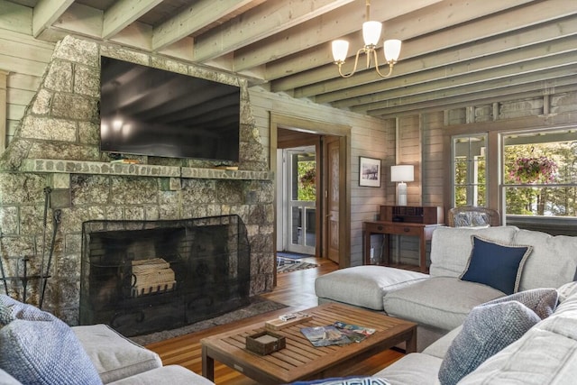 1 Mouse Is, Southport, ME 04576 - living room with beamed ceiling, a stone fireplace, and wood finished floors