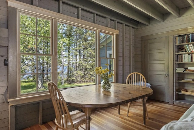 1 Mouse Is, Southport, ME 04576 - dining space with wooden walls, wood finished floors, healthy amount of natural light, and beam ceiling