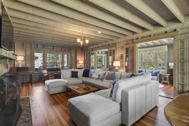 1 Mouse Is, Southport, ME 04576 - living room with a chandelier, wooden walls, healthy amount of natural light, wood finished floors, and beamed ceiling