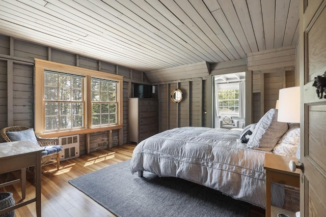 1 Mouse Is, Southport, ME 04576 - bedroom with wooden walls, wood finished floors, radiator, and wood ceiling