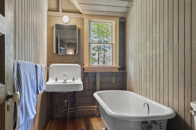 1 Mouse Is, Southport, ME 04576 - bathroom featuring a soaking tub, wood finished floors, and wood walls