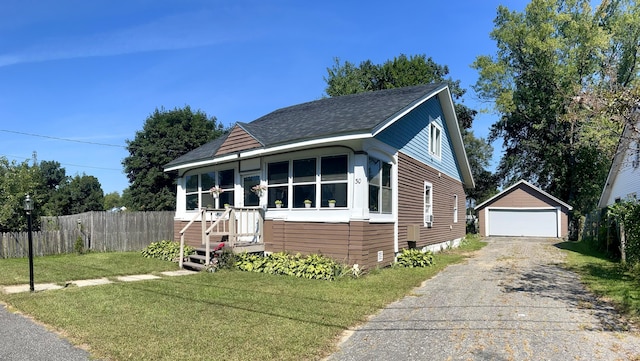 30 Highland Ave, Dixfield, ME 04224 - view of front of house featuring an outdoor structure, a shingled roof, and a detached garage