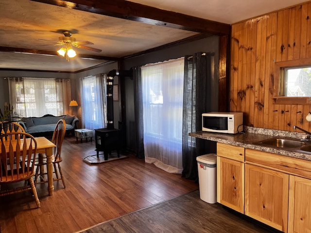 30 Highland Ave, Dixfield, ME 04224 - kitchen with a wood stove, white microwave, a sink, a ceiling fan, and dark wood-type flooring