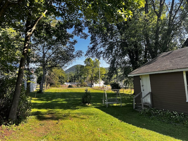 30 Highland Ave, Dixfield, ME 04224 - view of green lawn featuring entry steps and a mountain view