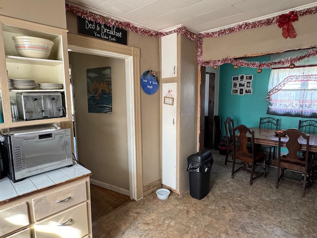 1345 Main St, Washburn, ME 04786 - kitchen with tile counters, tile patterned floors, and baseboards
