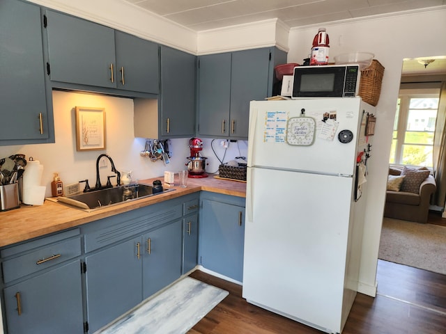 65 Pearce Ave, Houlton, ME 04730 - kitchen with freestanding refrigerator, black microwave, a sink, dark wood-style flooring, and light countertops