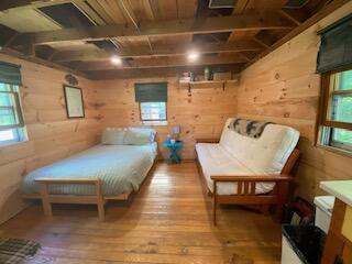 254 Eaton Rd, Dexter, ME 04435 - bedroom featuring wood walls and wood-type flooring
