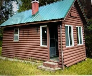 254 Eaton Rd, Dexter, ME 04435 - view of side of property with a chimney and metal roof