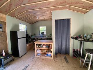 254 Eaton Rd, Dexter, ME 04435 - kitchen featuring freestanding refrigerator and vaulted ceiling