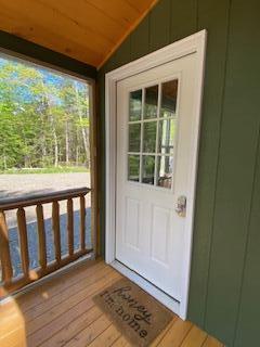 254 Eaton Rd, Dexter, ME 04435 - doorway to outside with vaulted ceiling and light wood-style flooring