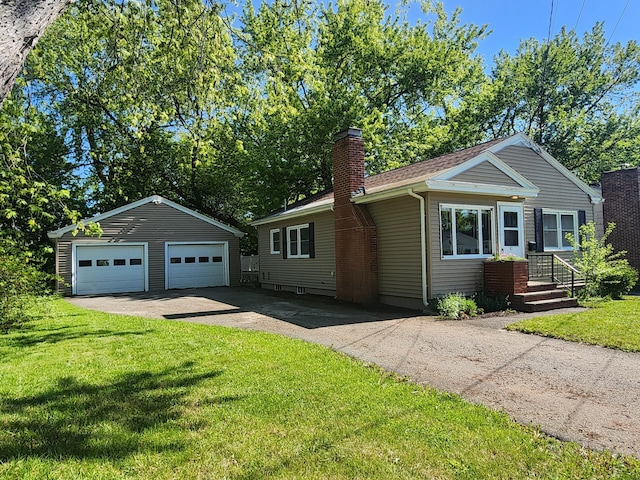 51 Francis St, Waterville, ME 04901 - single story home featuring an outdoor structure, a detached garage, a chimney, and a front yard